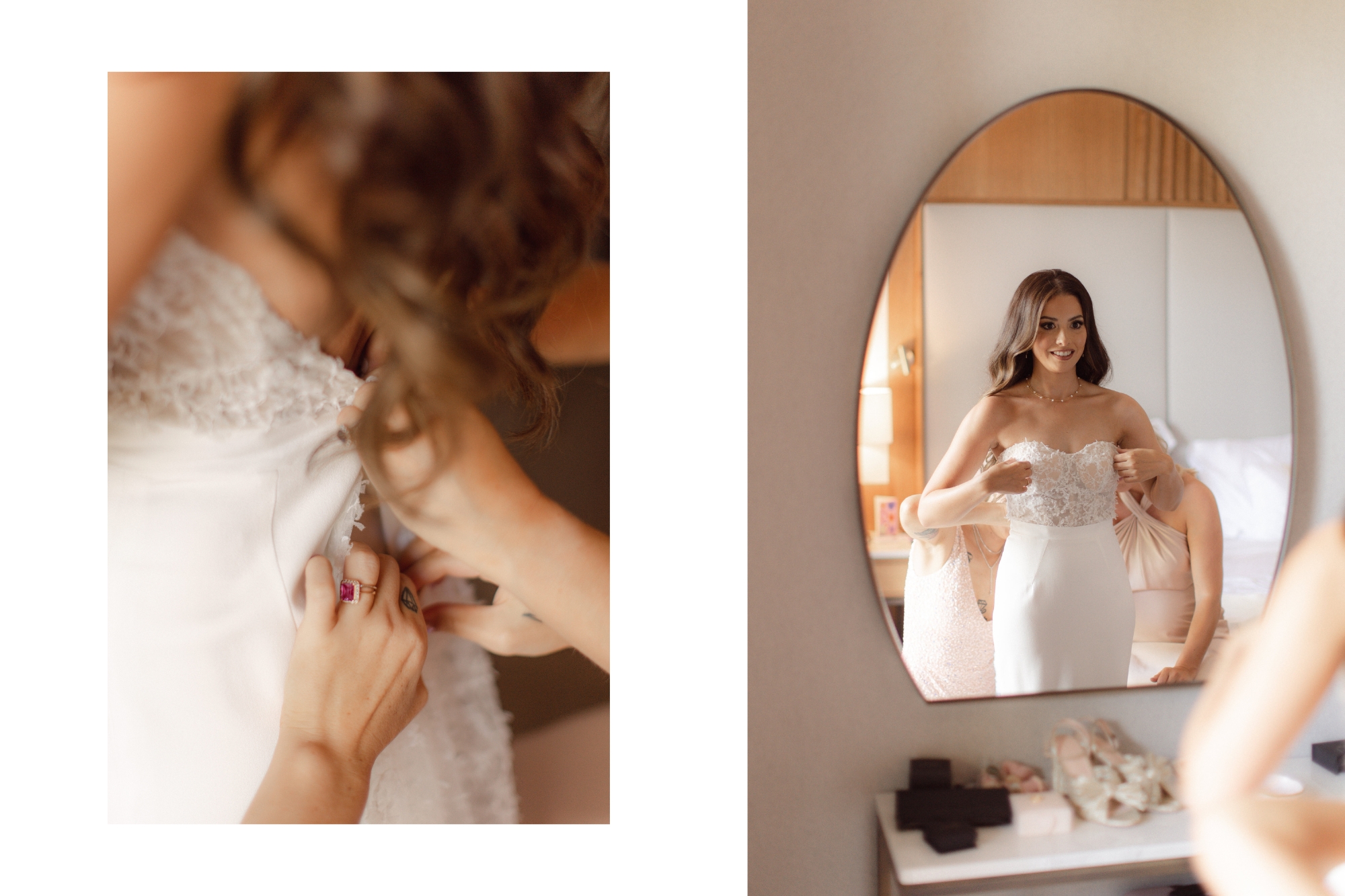 Bride wearing wedding dress standing in front of round mirror with assistance zipping up gown in back
