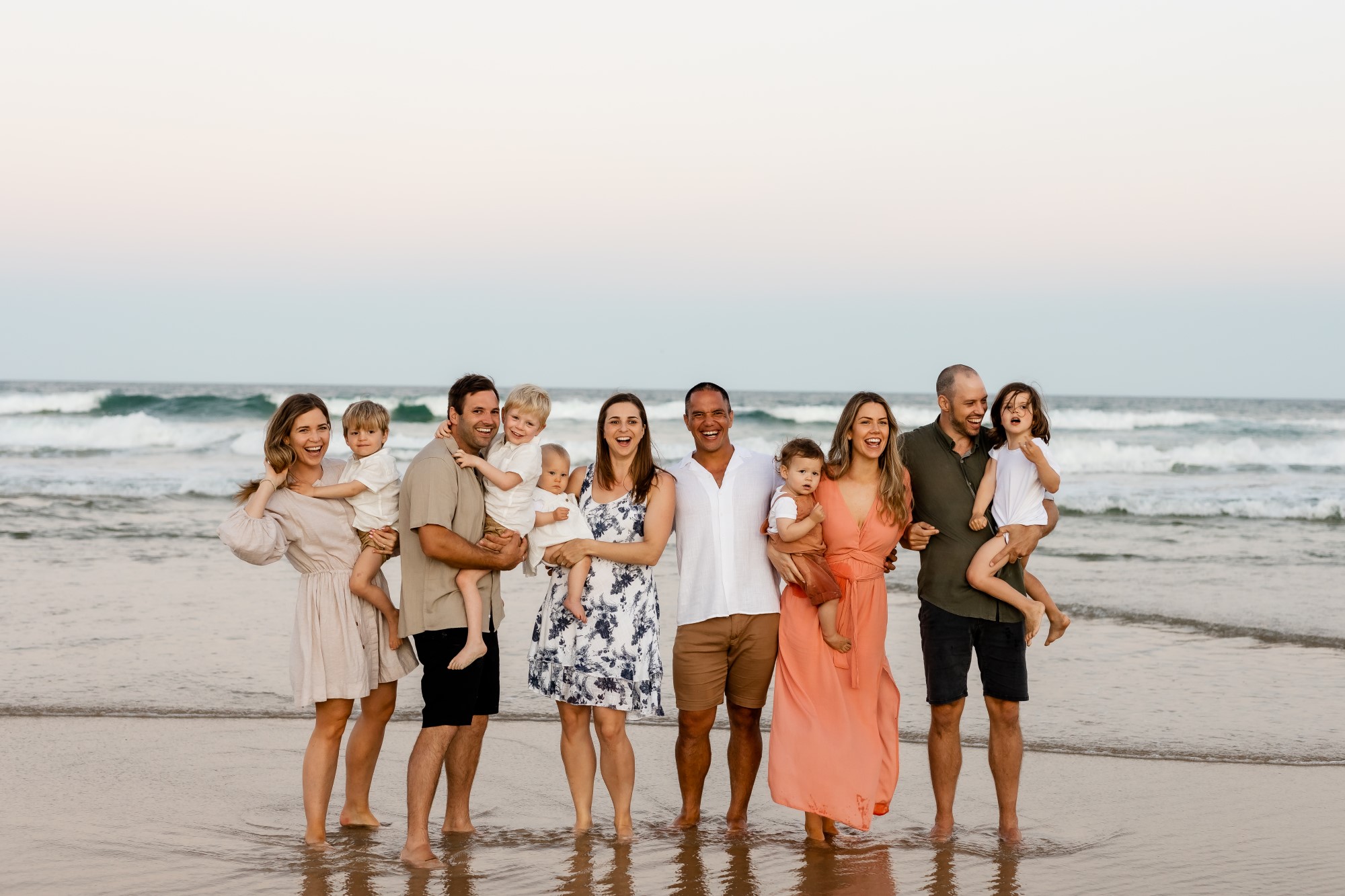 Family reunion together on beach at sunset