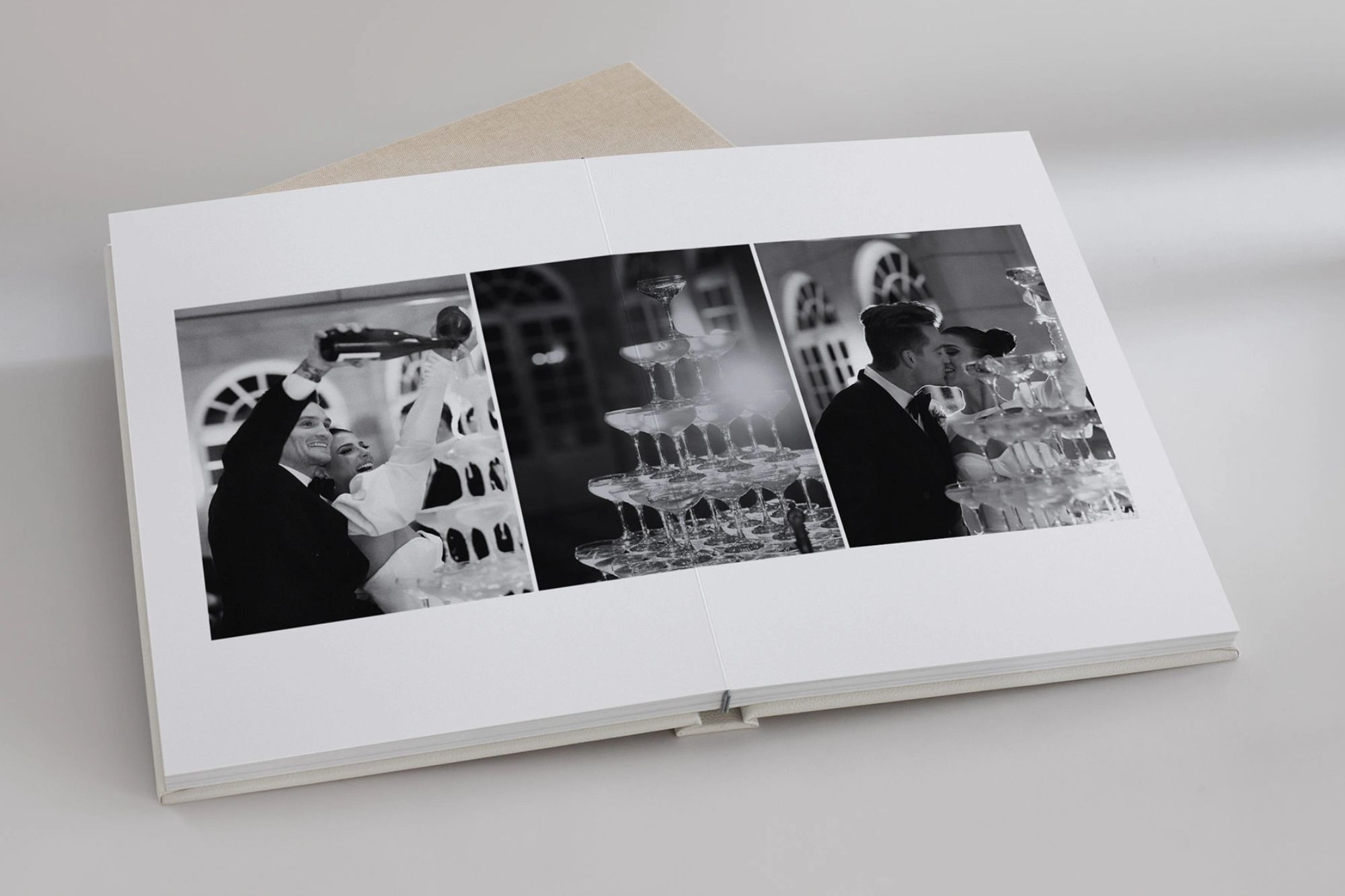 Open Photo Album with bride and groom pouring over champagne tower.