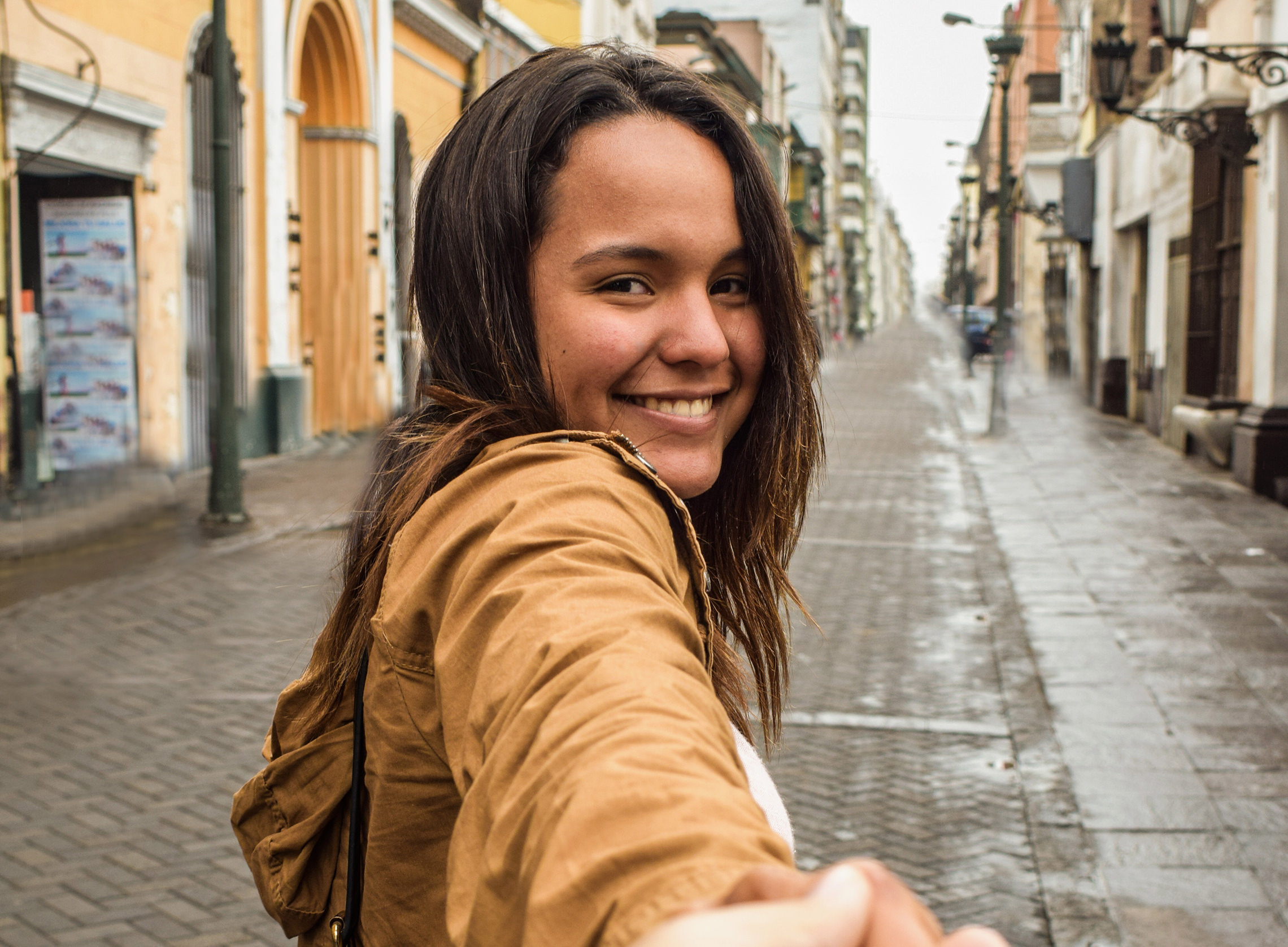 Girl holding photographers hand.
