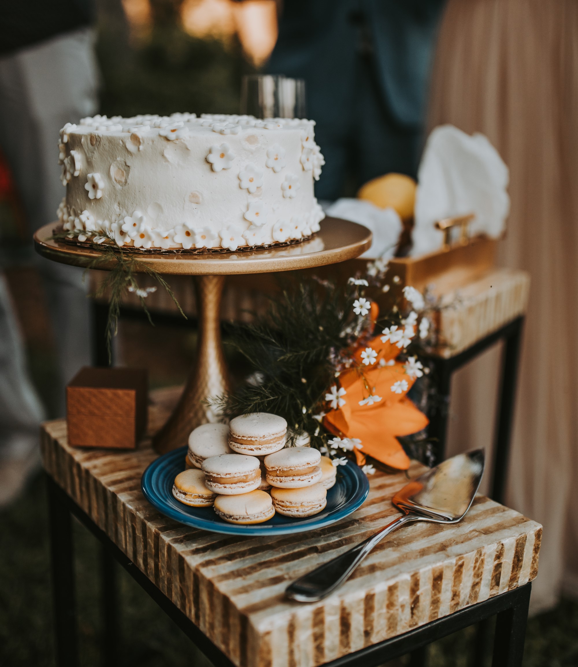 Single tier wedding cake and plate of macarons
