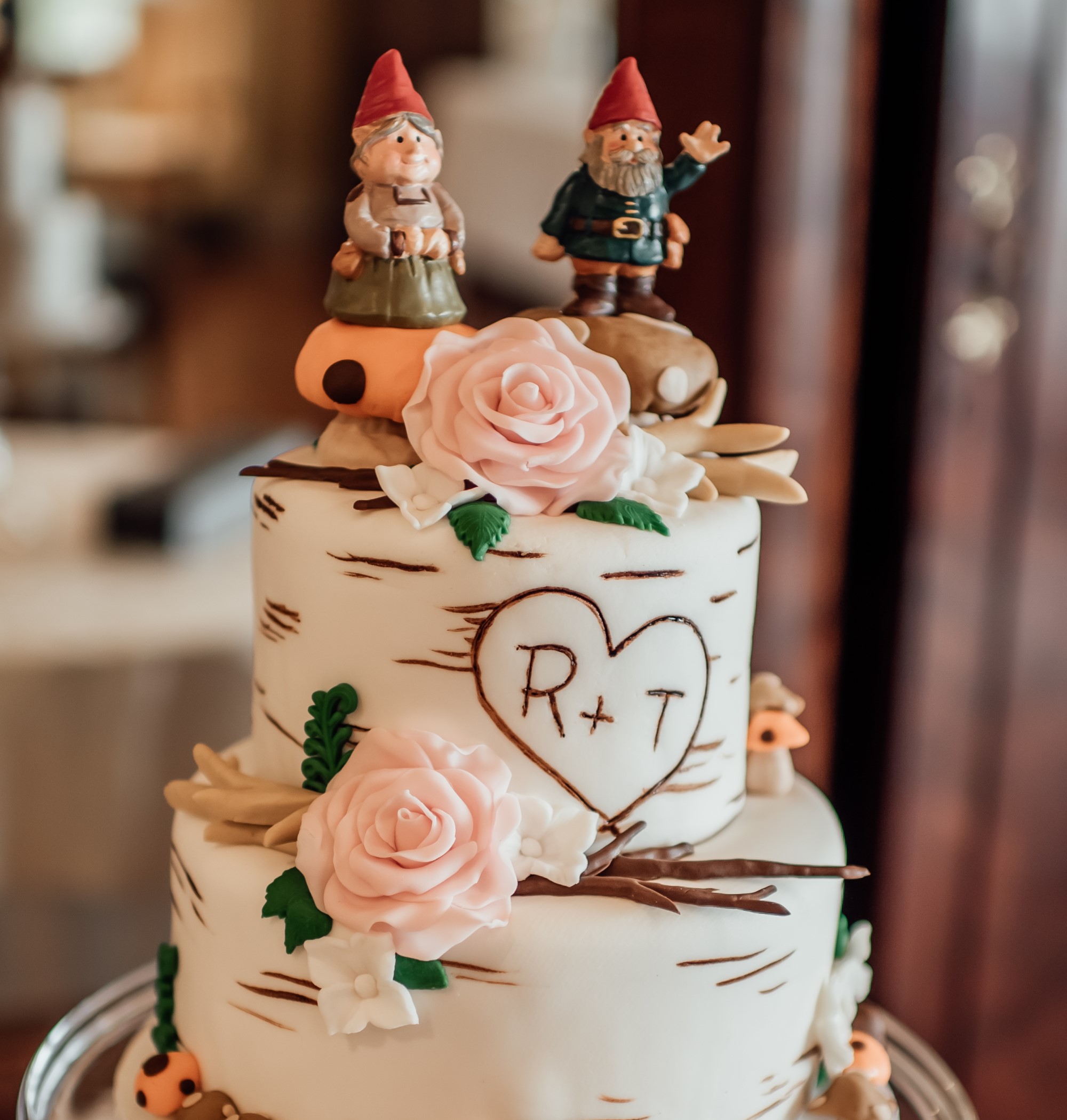 Two tiered wedding cake with gnome cake toppers