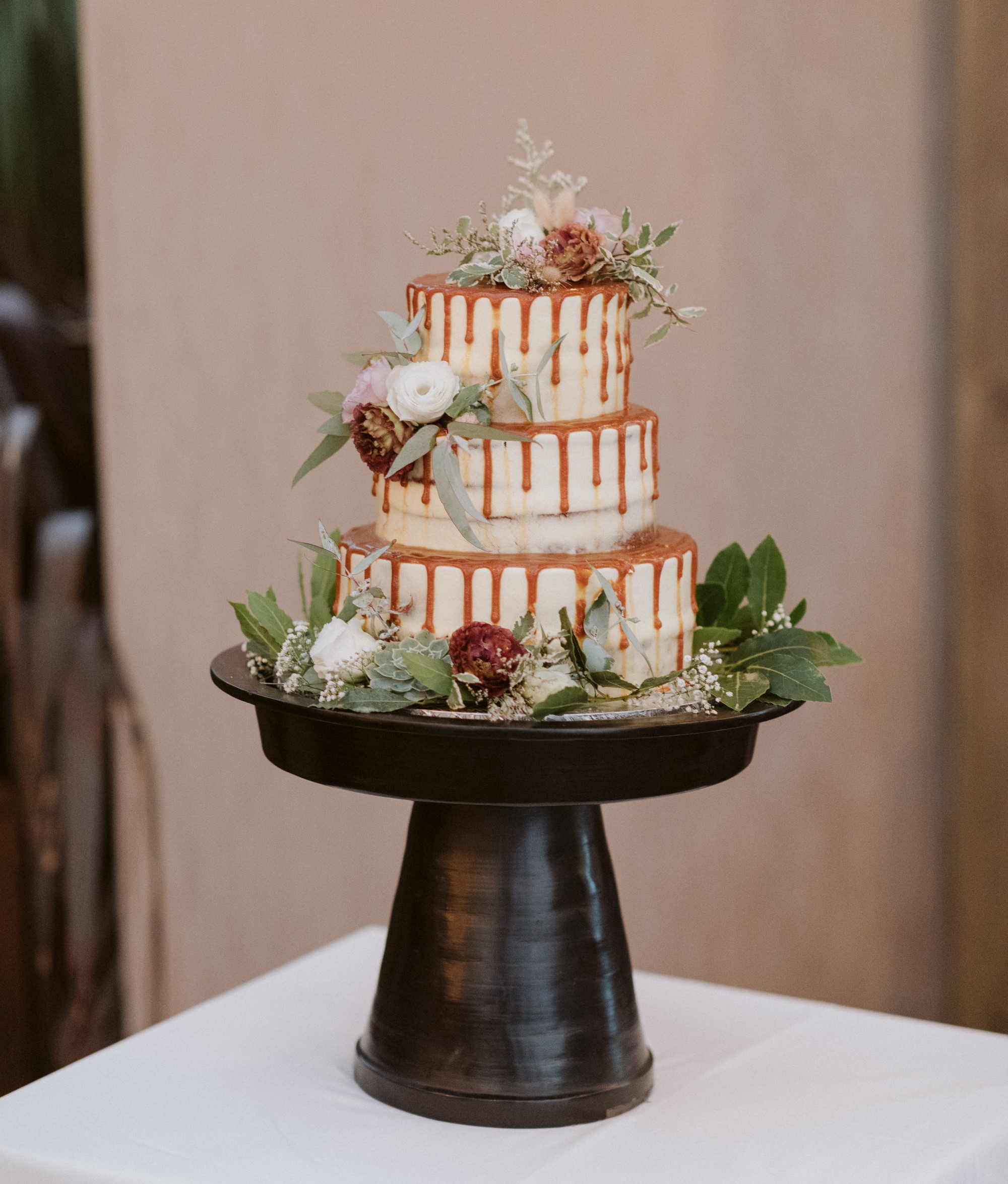 Three tiered wedding cake with caramel drizzle
