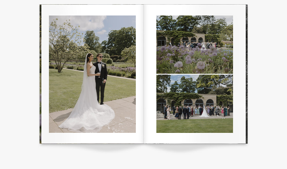 Wedding Magazine with photos of newlywed couple stand together smiling on footpath by lush gardens