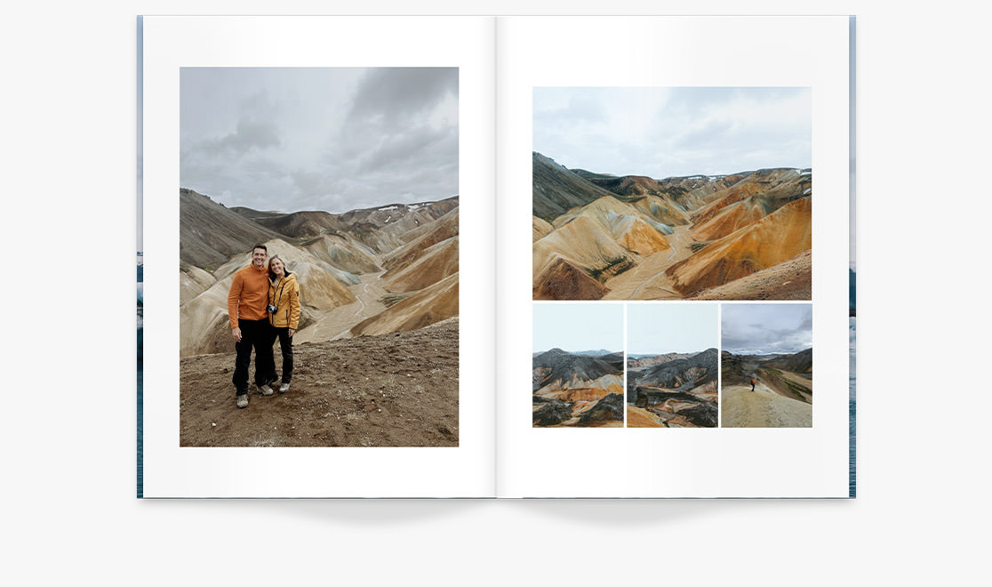 Two friends posing together in front of hilly valley in Iceland on overcast day