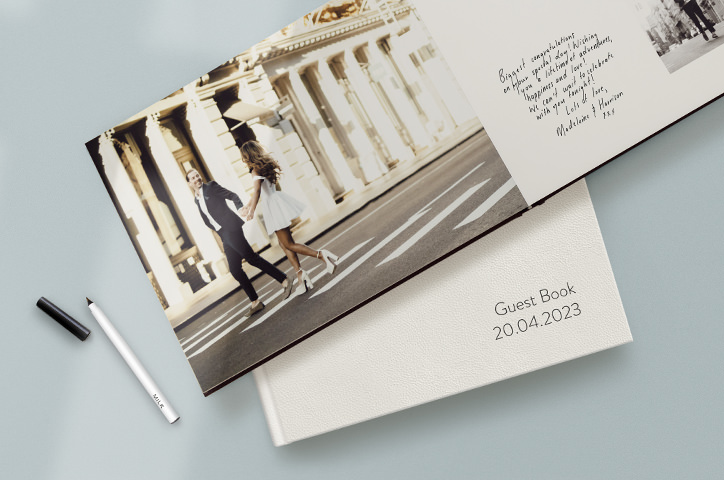 A wedding Guest book laid open with warm messages from wedding guests written on the pages.