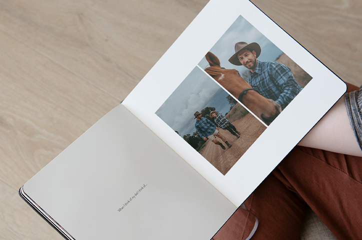 Father and son together with child on father's back displayed on photo book