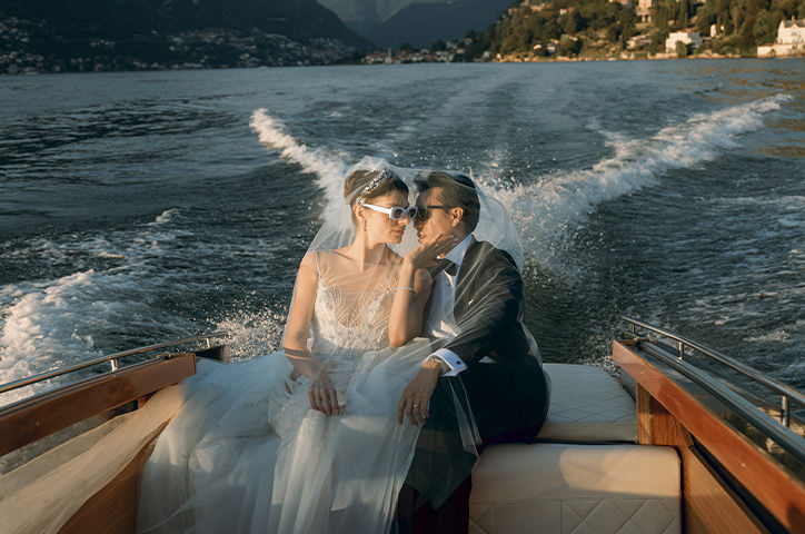 Newlyweds riding on a boat on Lake Como