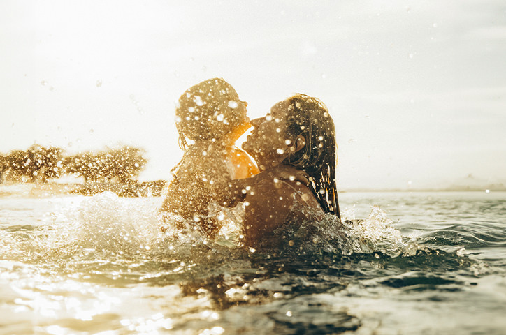 Mother and child playing in the sea