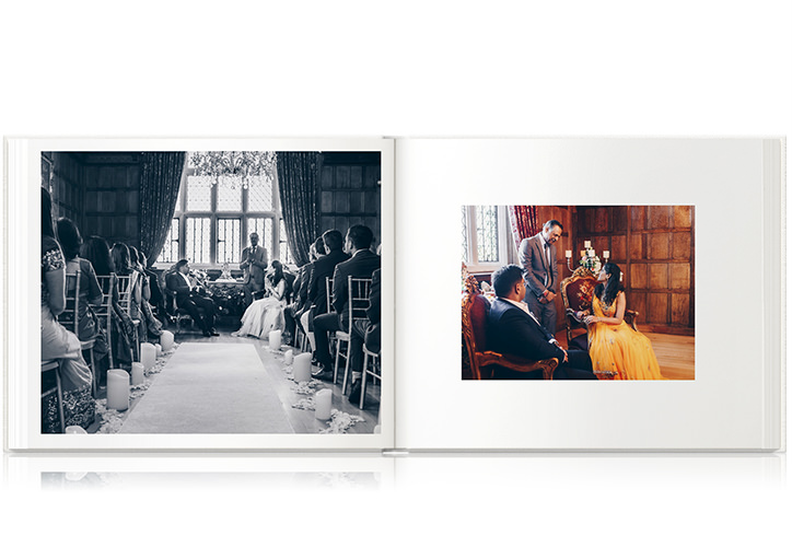 Open landscape photo album showing beautiful engagement party in old antique library and bride wears yellow dress