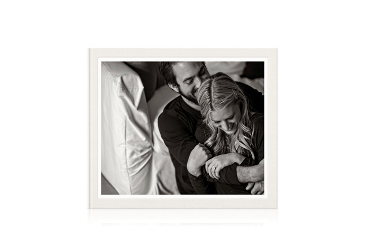 Beige square photo album with picture of happy couple in black and white filter on cover
