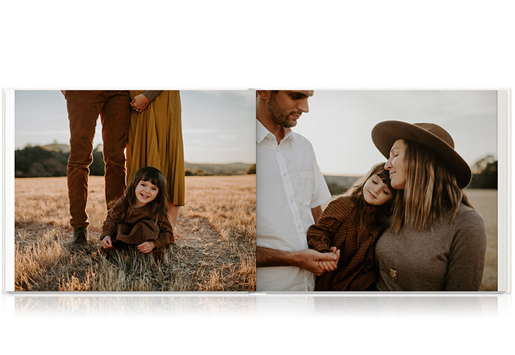 Family of three in dry grass field together in late afternoon