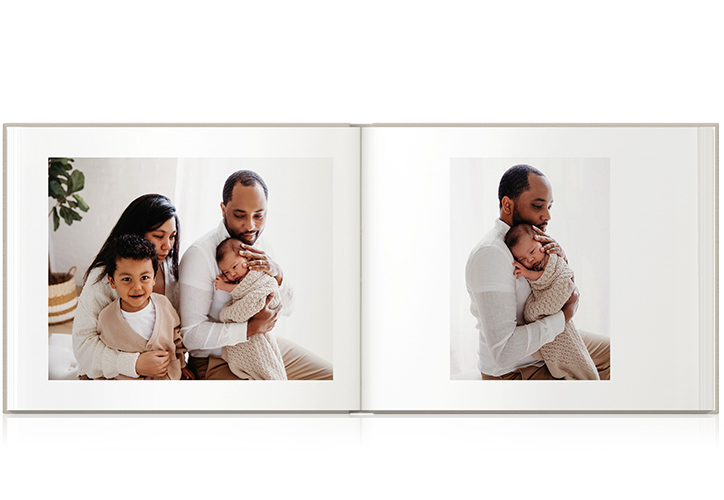 Family wearing white with son and baby held by father