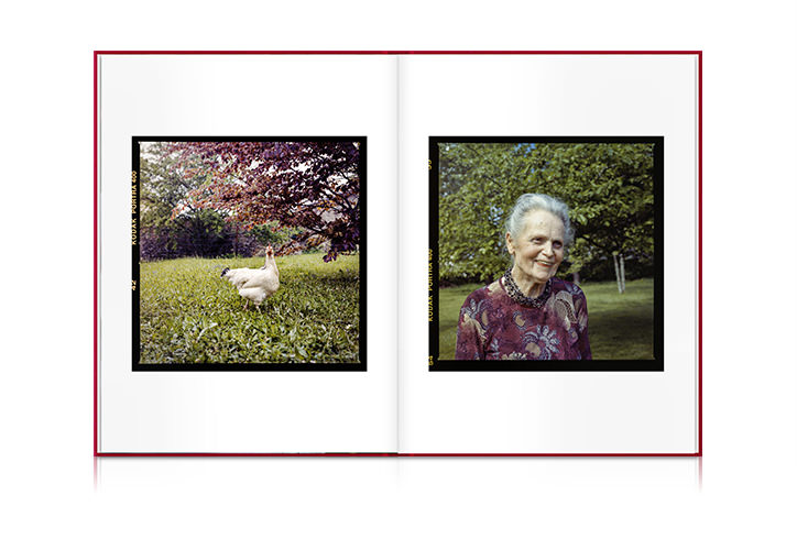 Red portrait photo book with polaroid pictures of a grandma and a chicken inside