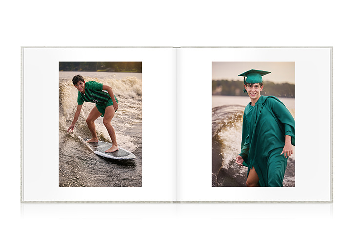 Male graduate in green robes and hat surfing in his graduation attire