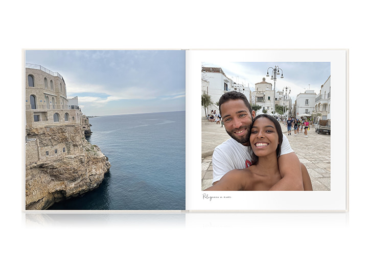 Open square photo book of honeymoon in Rome and France with diverse couple smiling