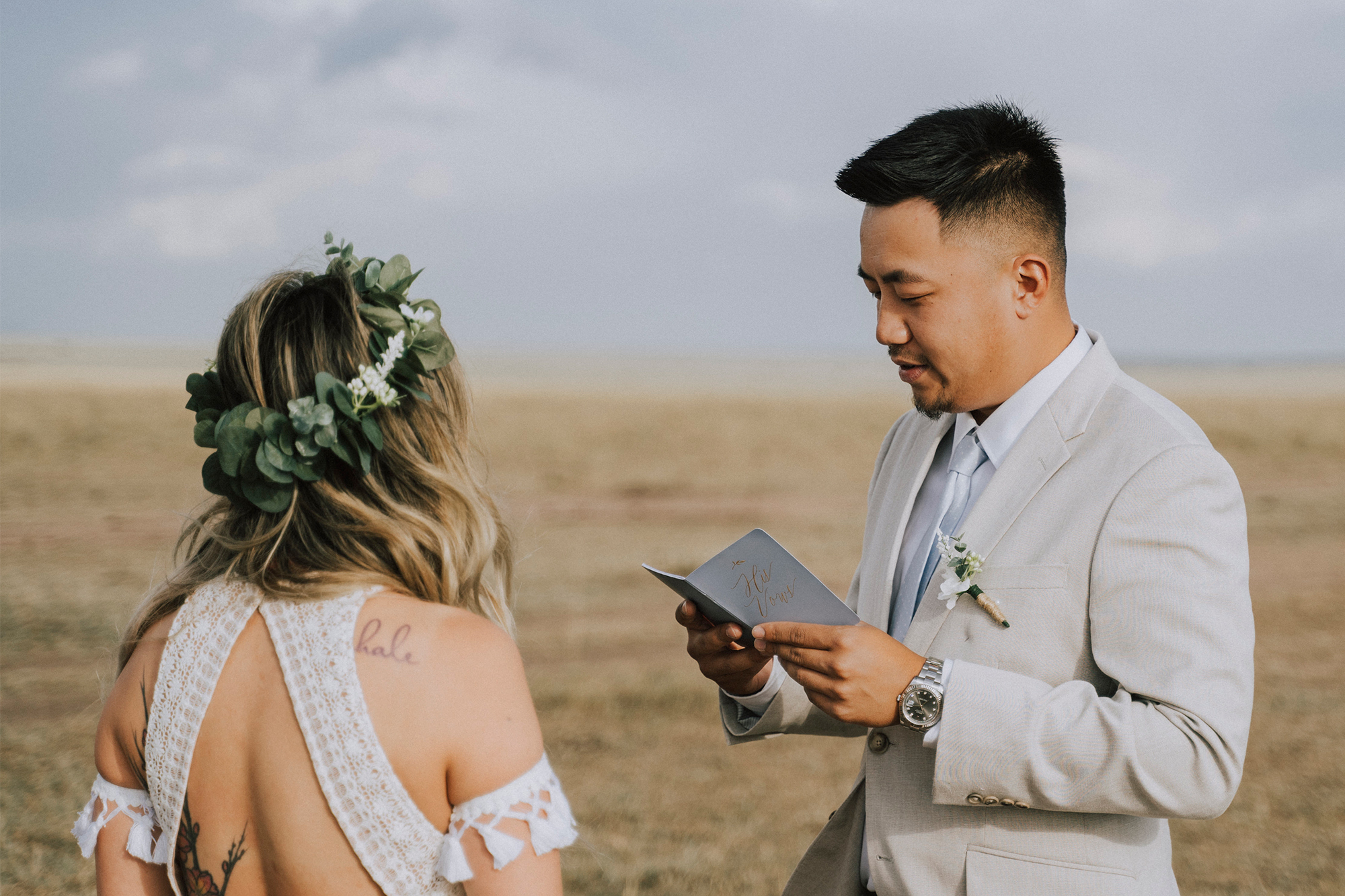 Man and woman eloping in Kenya, reading their vows to each other