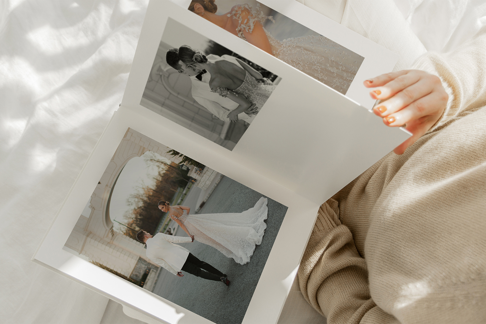 Woman looking through wedding photo album at home