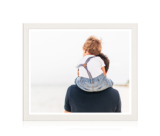 Large classic photo book with cover image of a young boy sitting on his father's shoulders