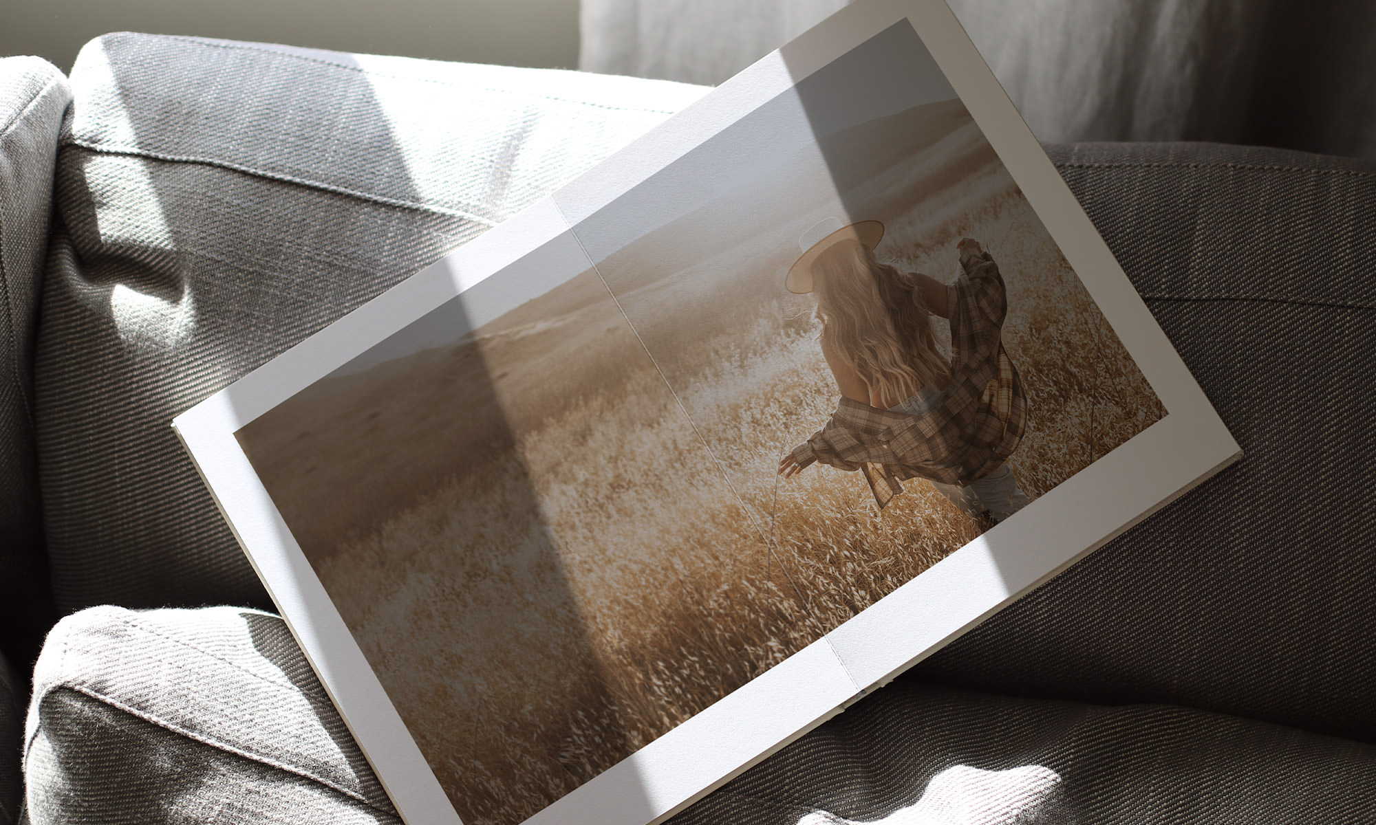 Lifestyle image of book on couch with full double page spread image