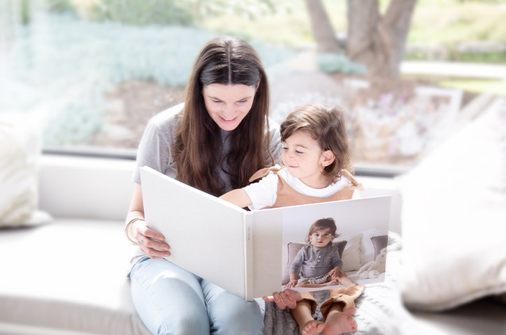 Mother and child read through Large Landscape Photo Book