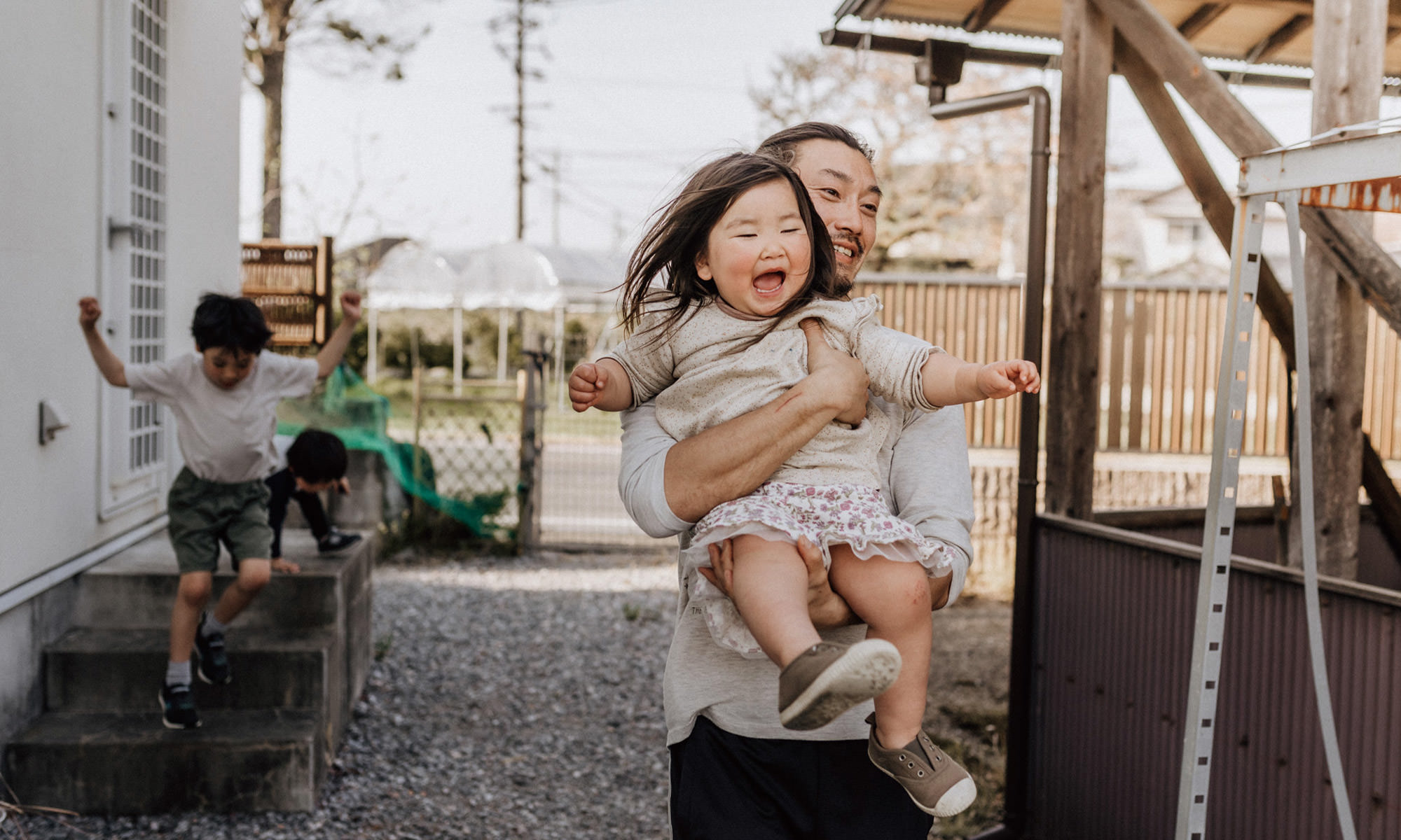 Father carrying laughing daughter