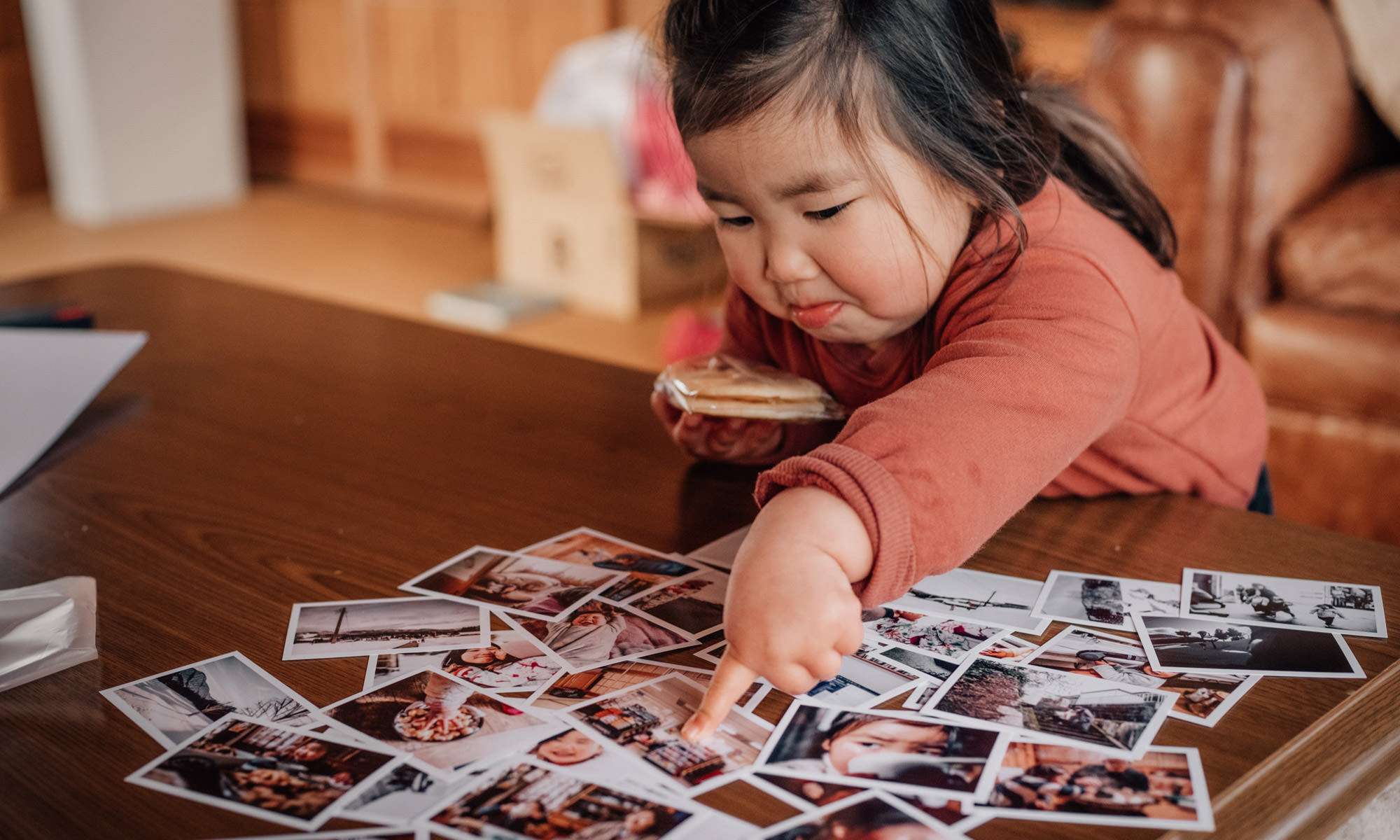 Little girl browsing through photos of her year