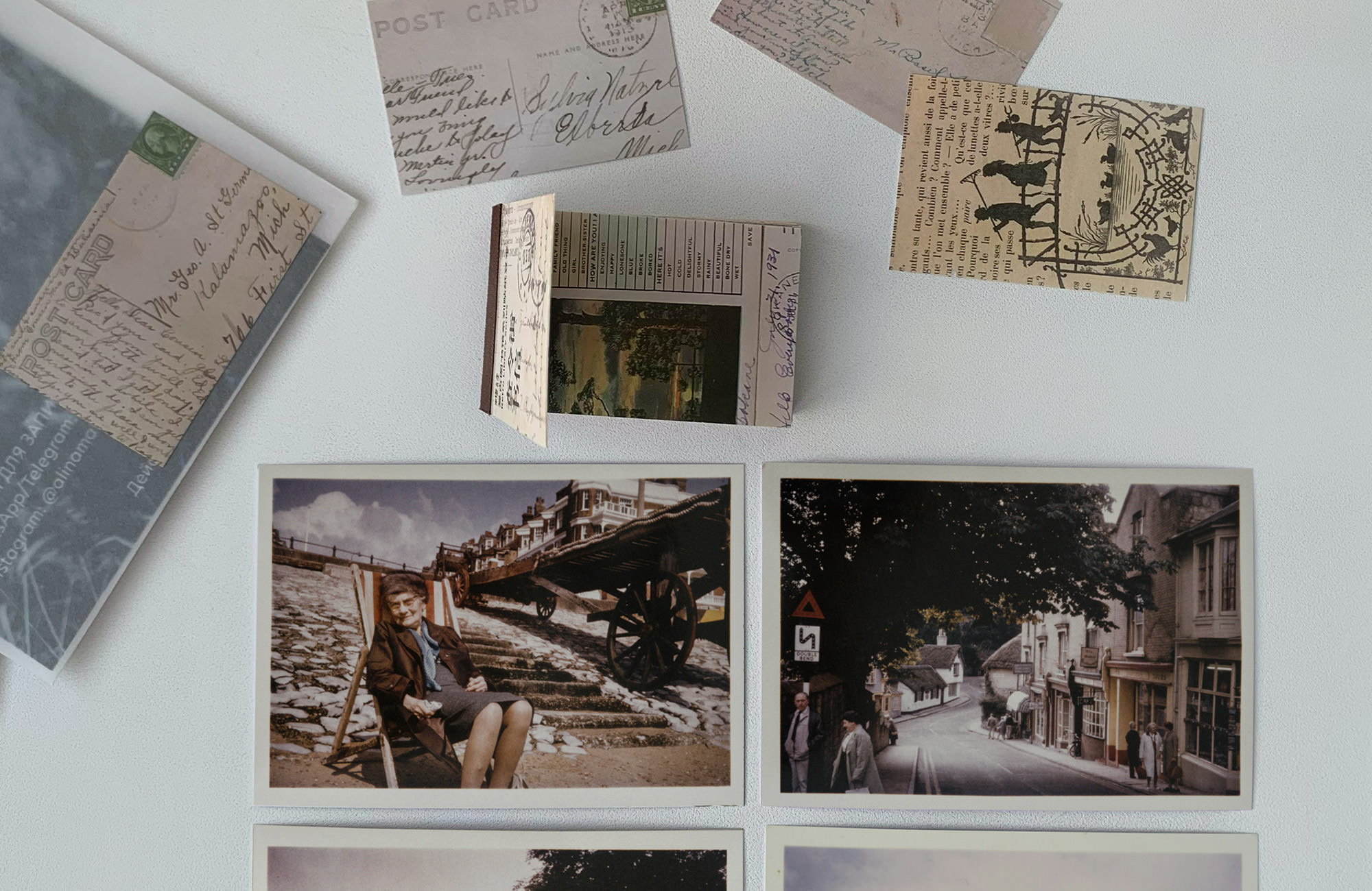 A collection of old images laying flat on a table