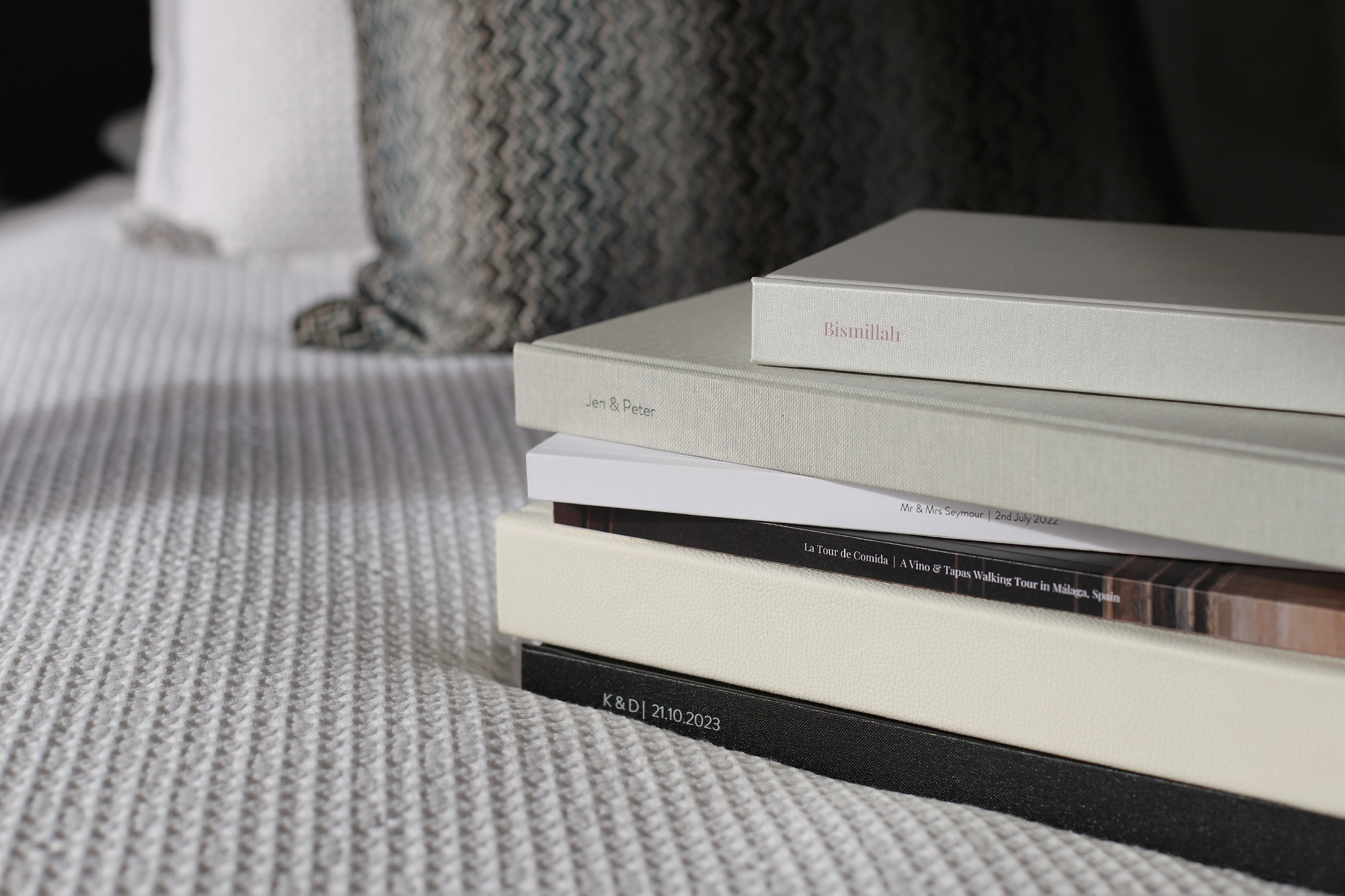 Stack of MILK Photo Books, Photo Albums and Magazines on a bed