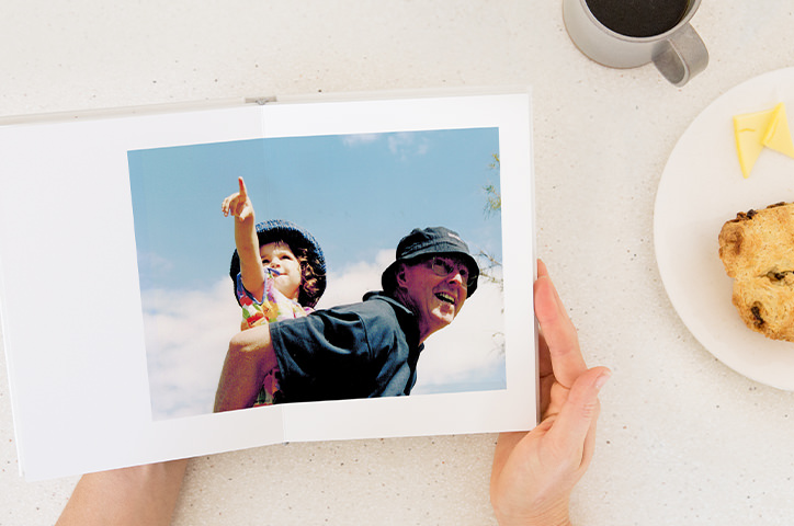 Open photo album with father and son