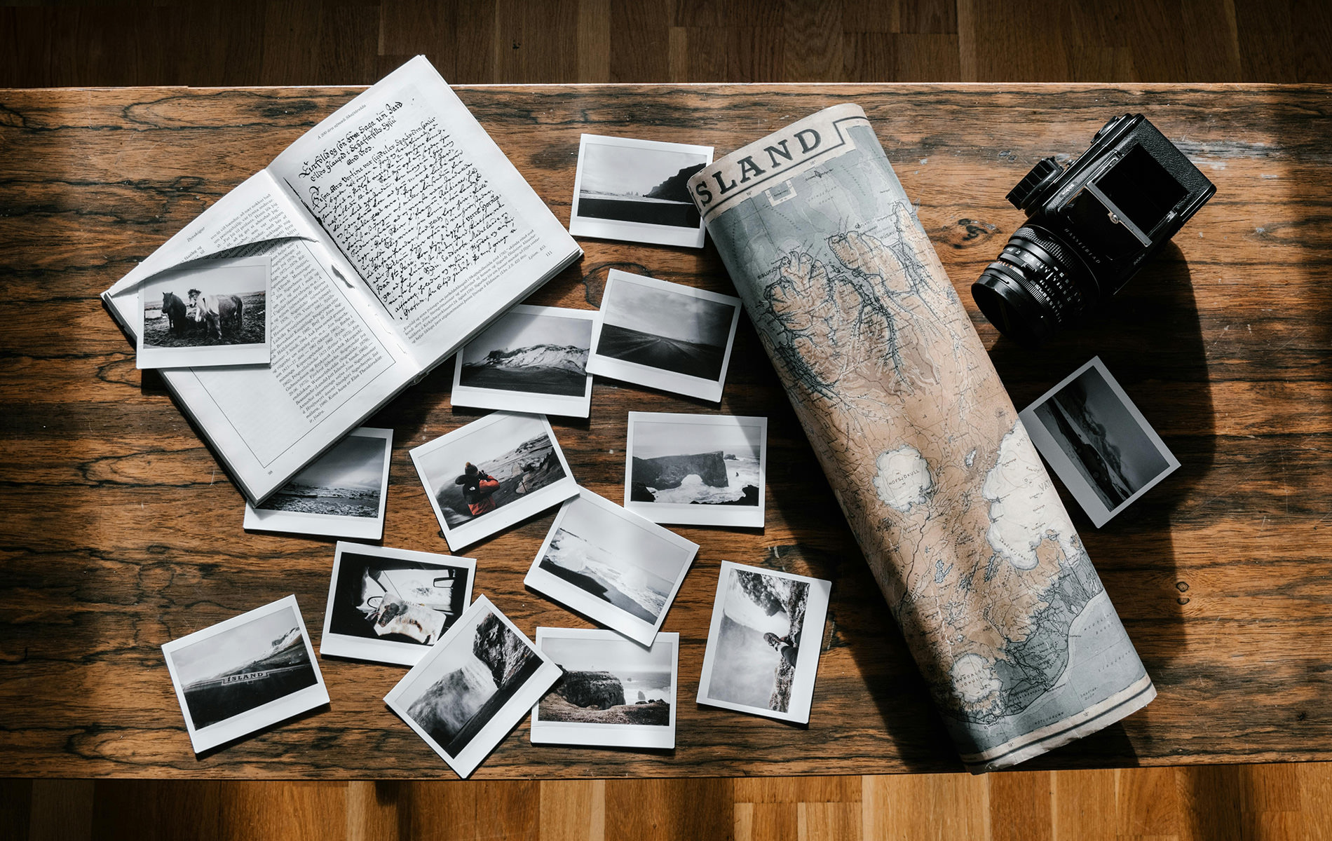 Laid out polaroid images, map and travel journal