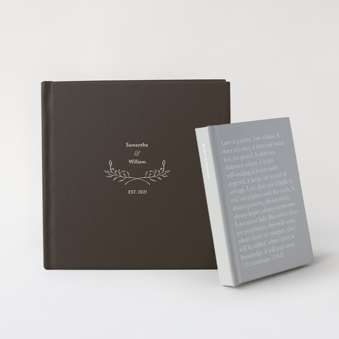 Two Premium Leather Photo Albums with Designer Covers standing in front of grey background