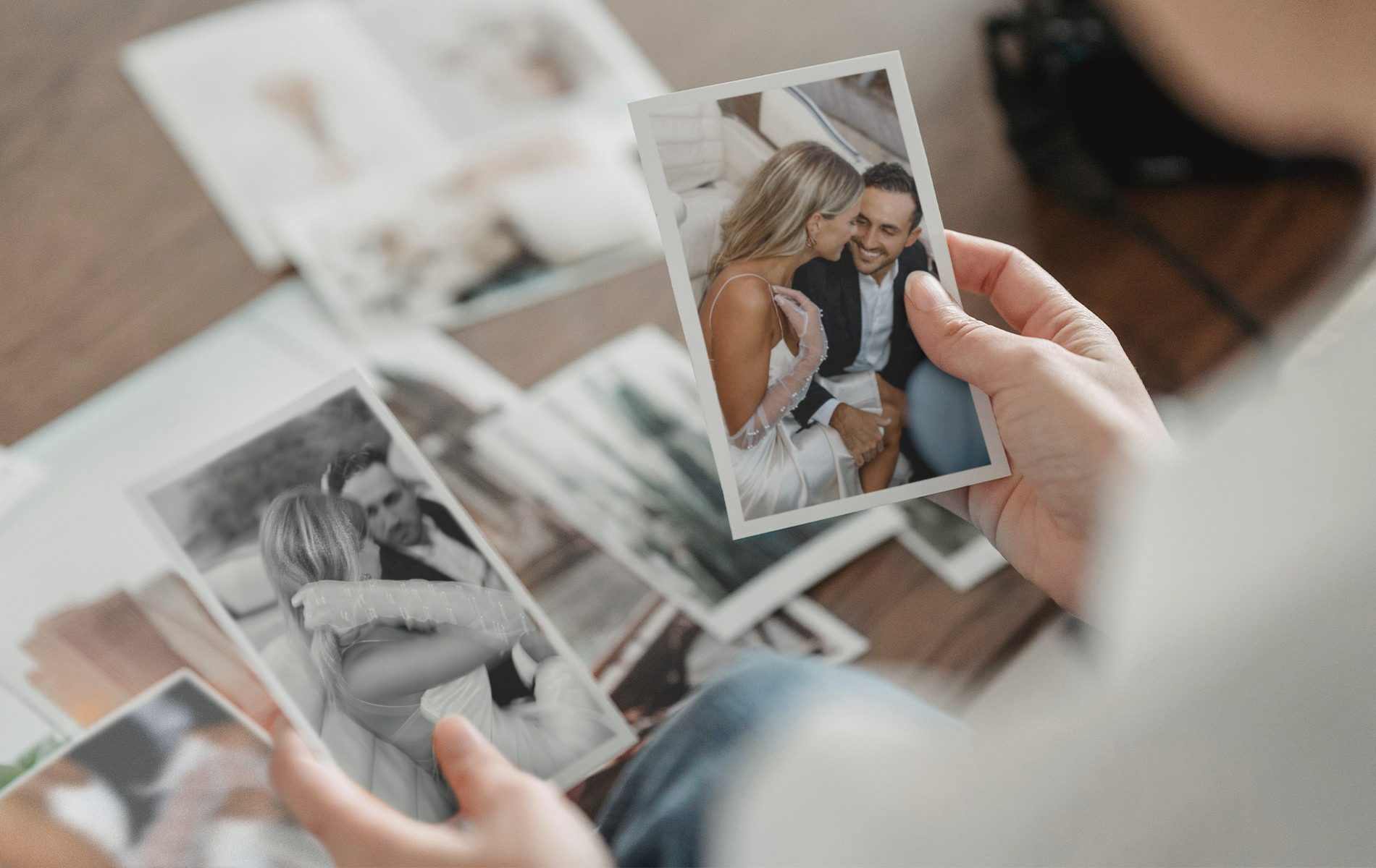 Choosing printing wedding photos laid out on table