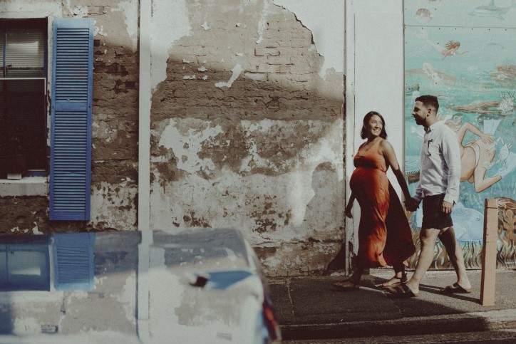 Pregnant couple walking down street