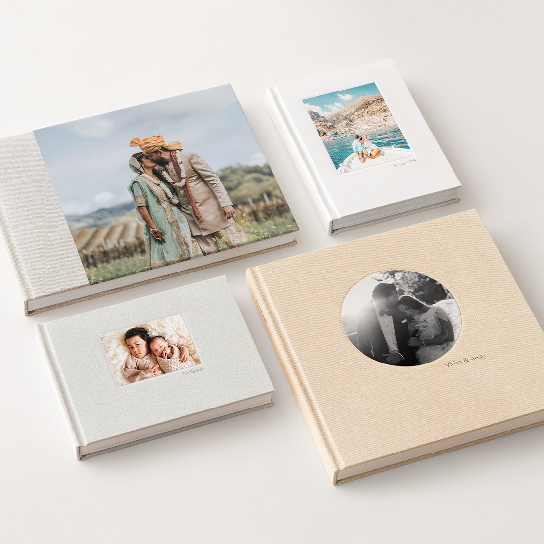 Four Photo Album orientations laid out on beige table