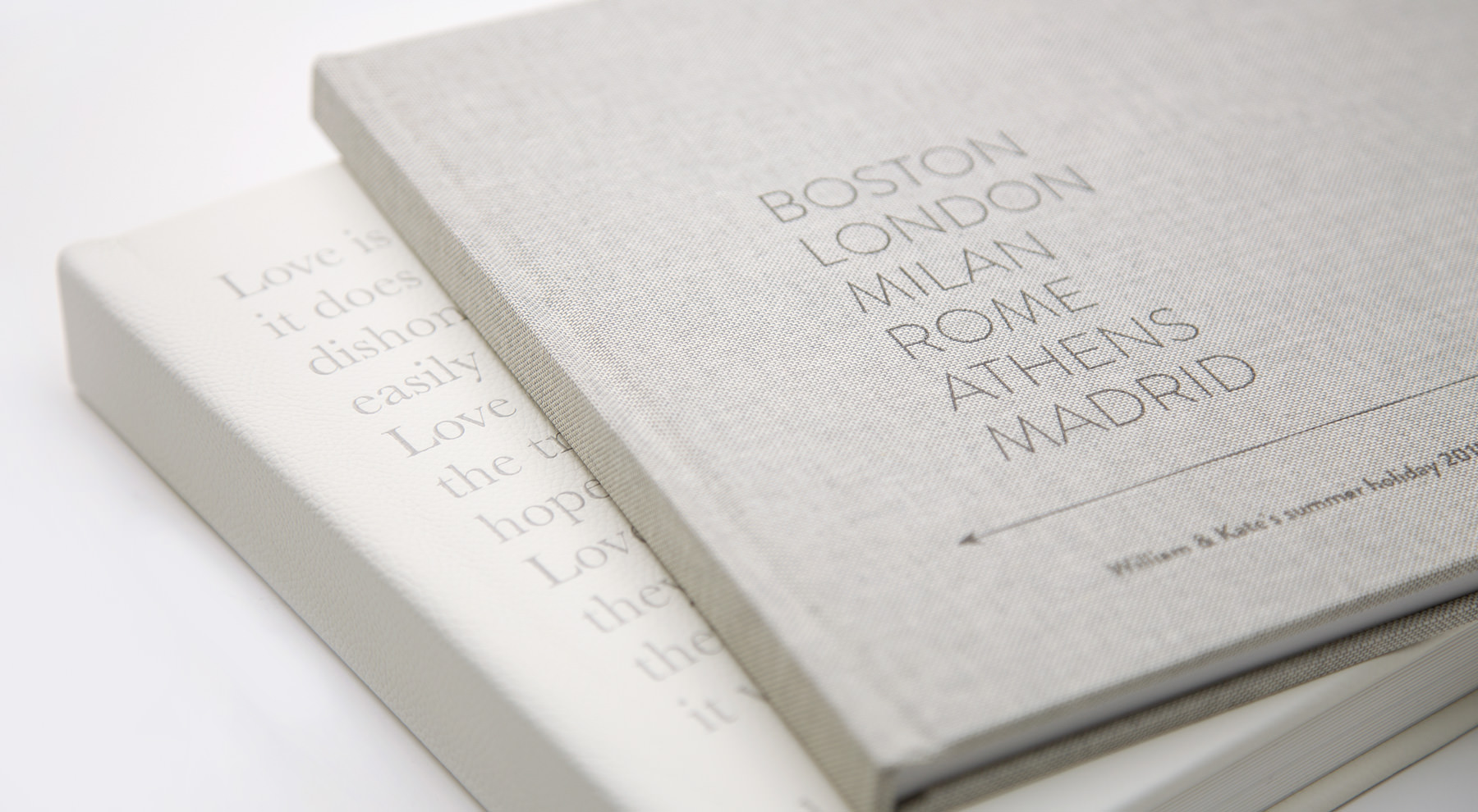 Two premium photo books showing designer covers