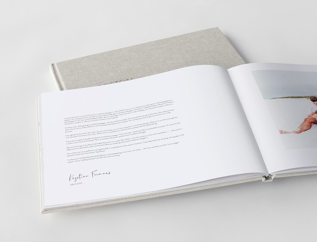 Open premium photo book showing text spread