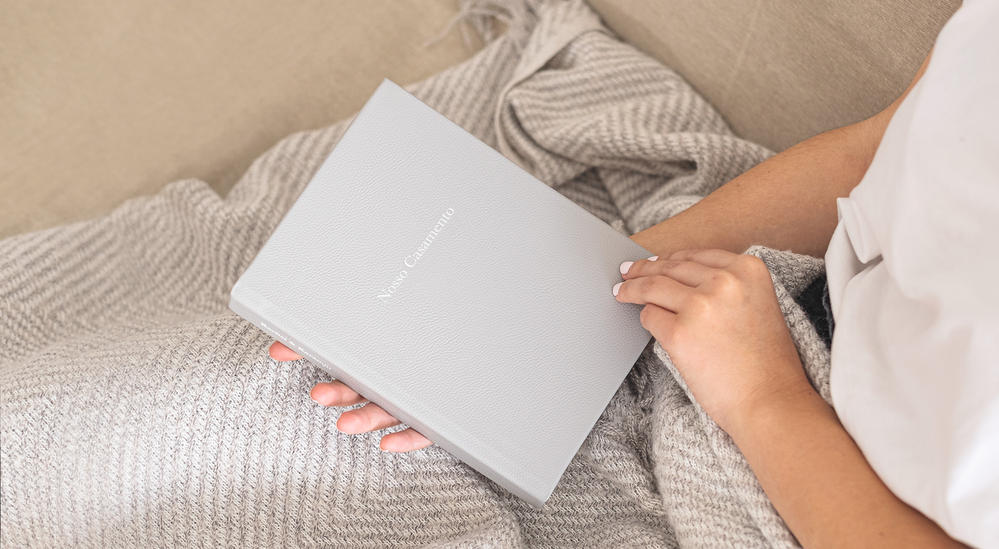 Woman holding medium premium photo album.