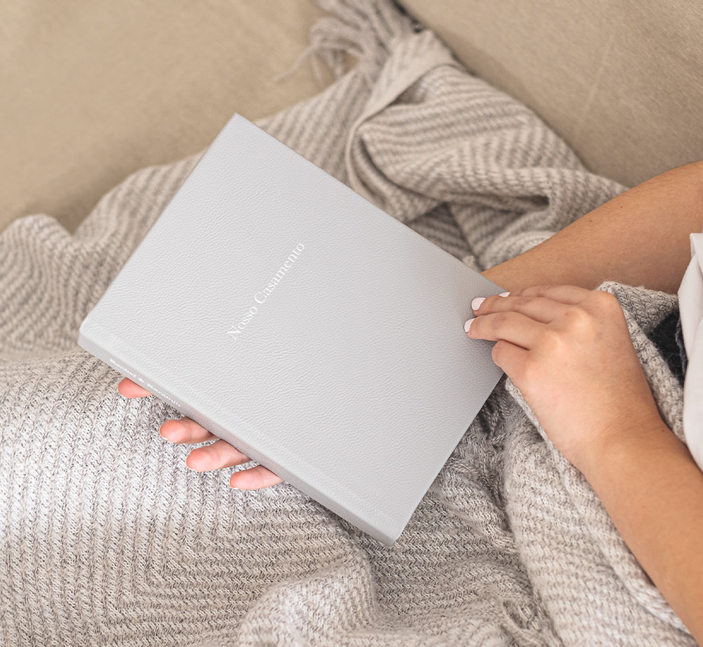 Woman holding medium premium photo album.