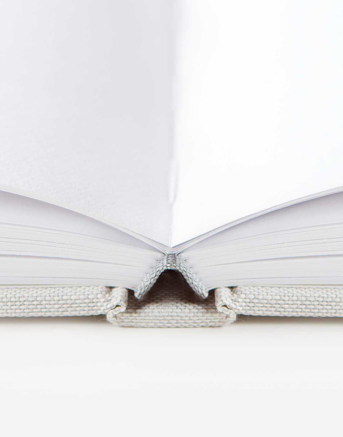 Closeup of premium photo book section-sewn binding.