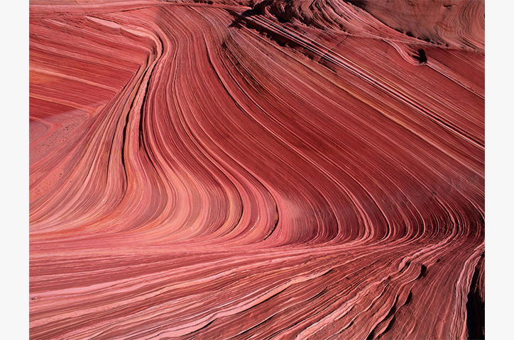 Photo of various layers of red paint up close