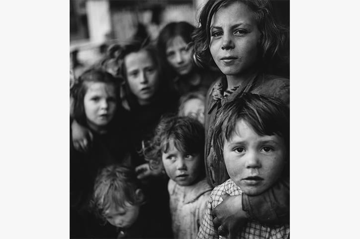 Monochrome photo of a group of six children looking at camera