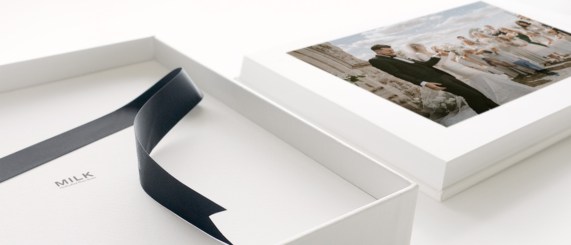 Wedding Photo Album next to open Presentation Box with black satin lift-out ribbon
