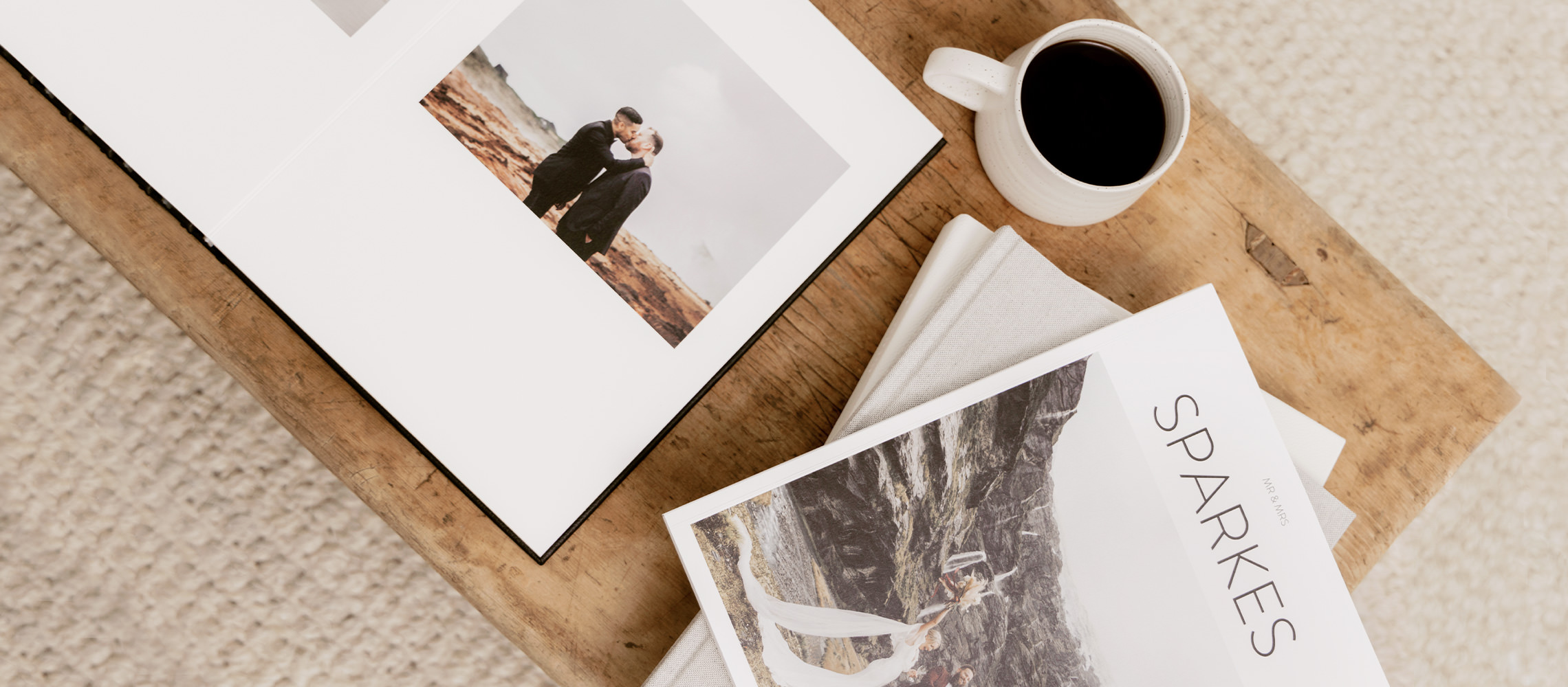 Open premium photo album and wedding magazine on coffee table