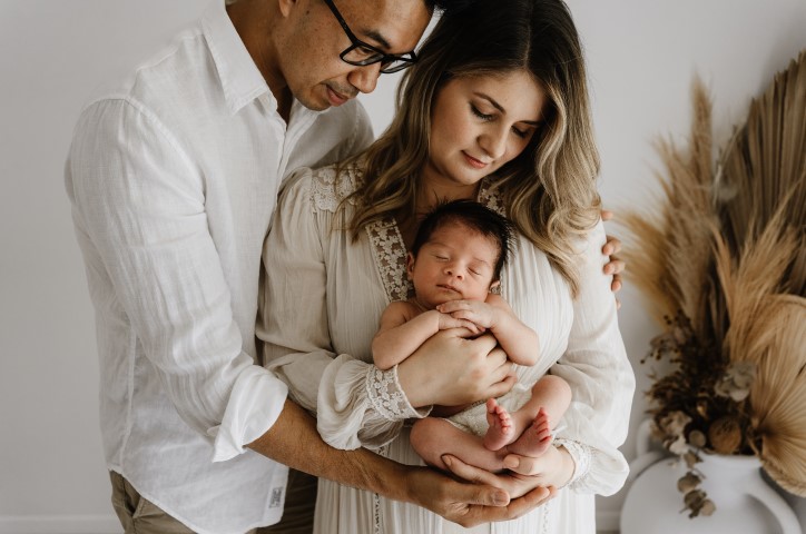 Family holding baby
