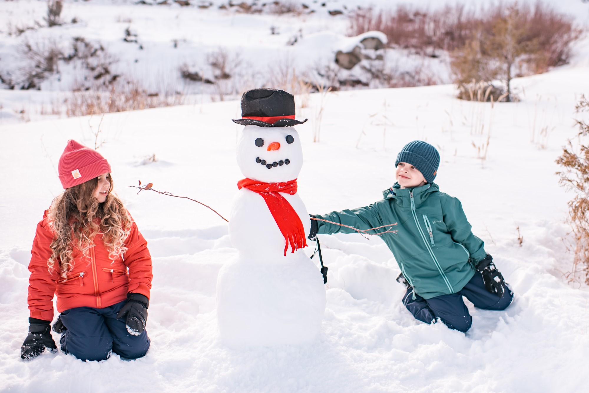 Boy and girl building a snowman