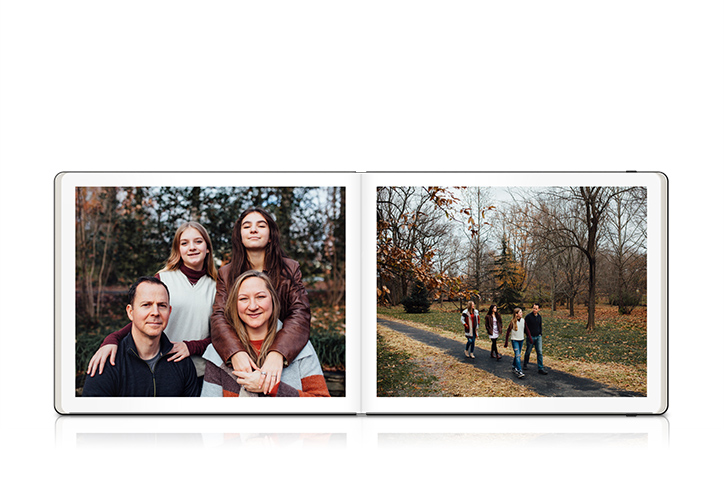 Open Moleskine Photo Book with spread of family photos outdoors