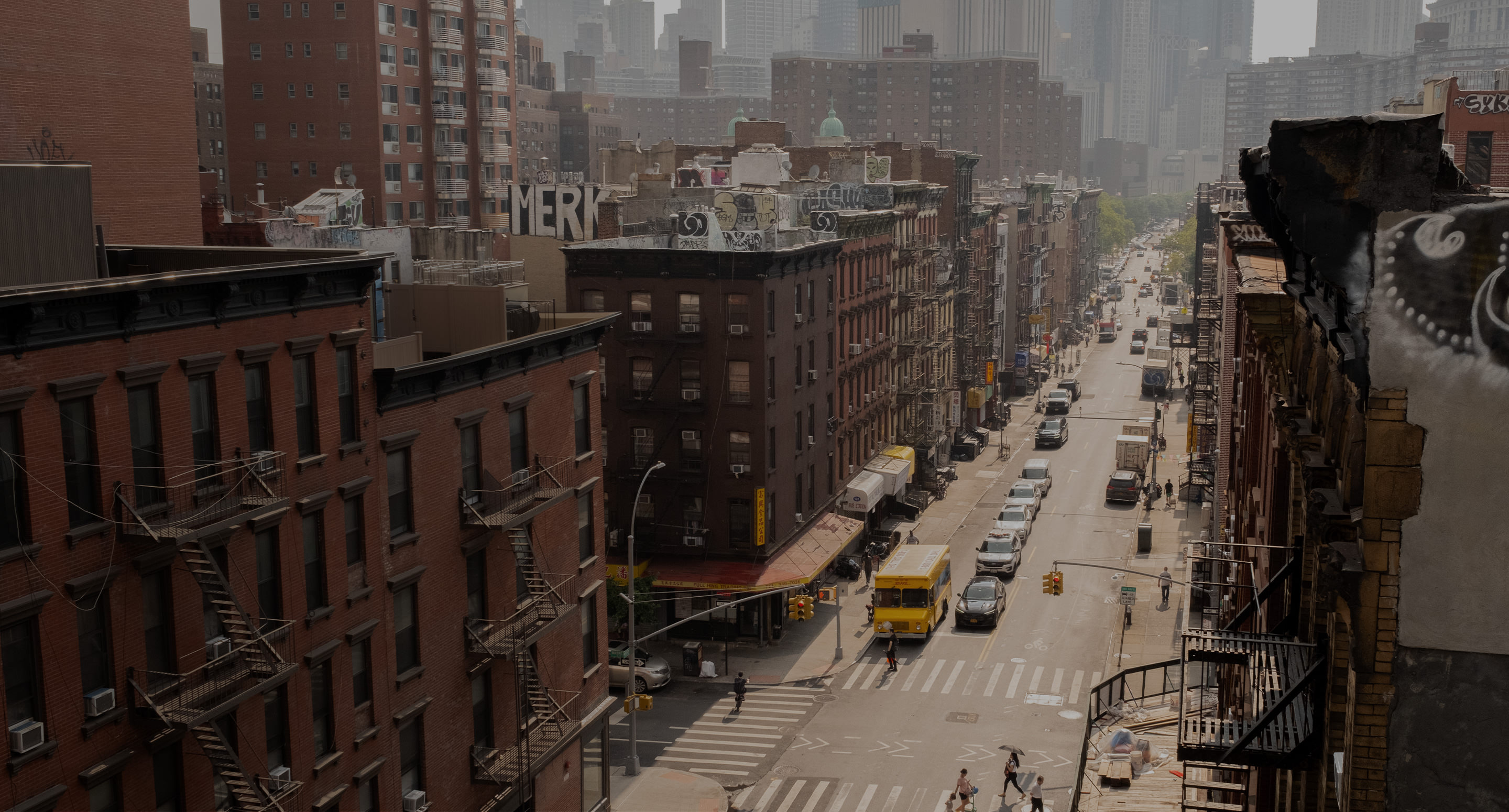 Wide shot overlooking busy New York street with brown buildings