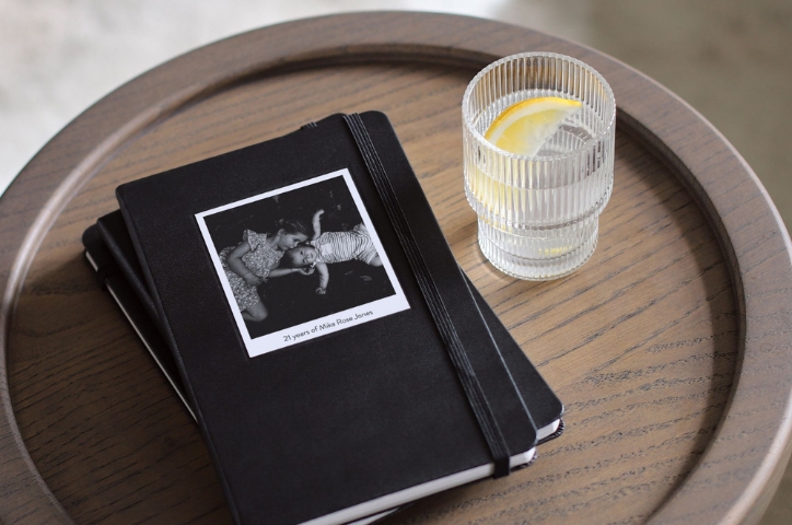 Book on a desk with a glass of water with lemon