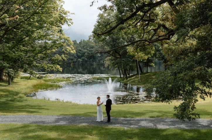 Photo of Bride and Groom in forest in front of fountain